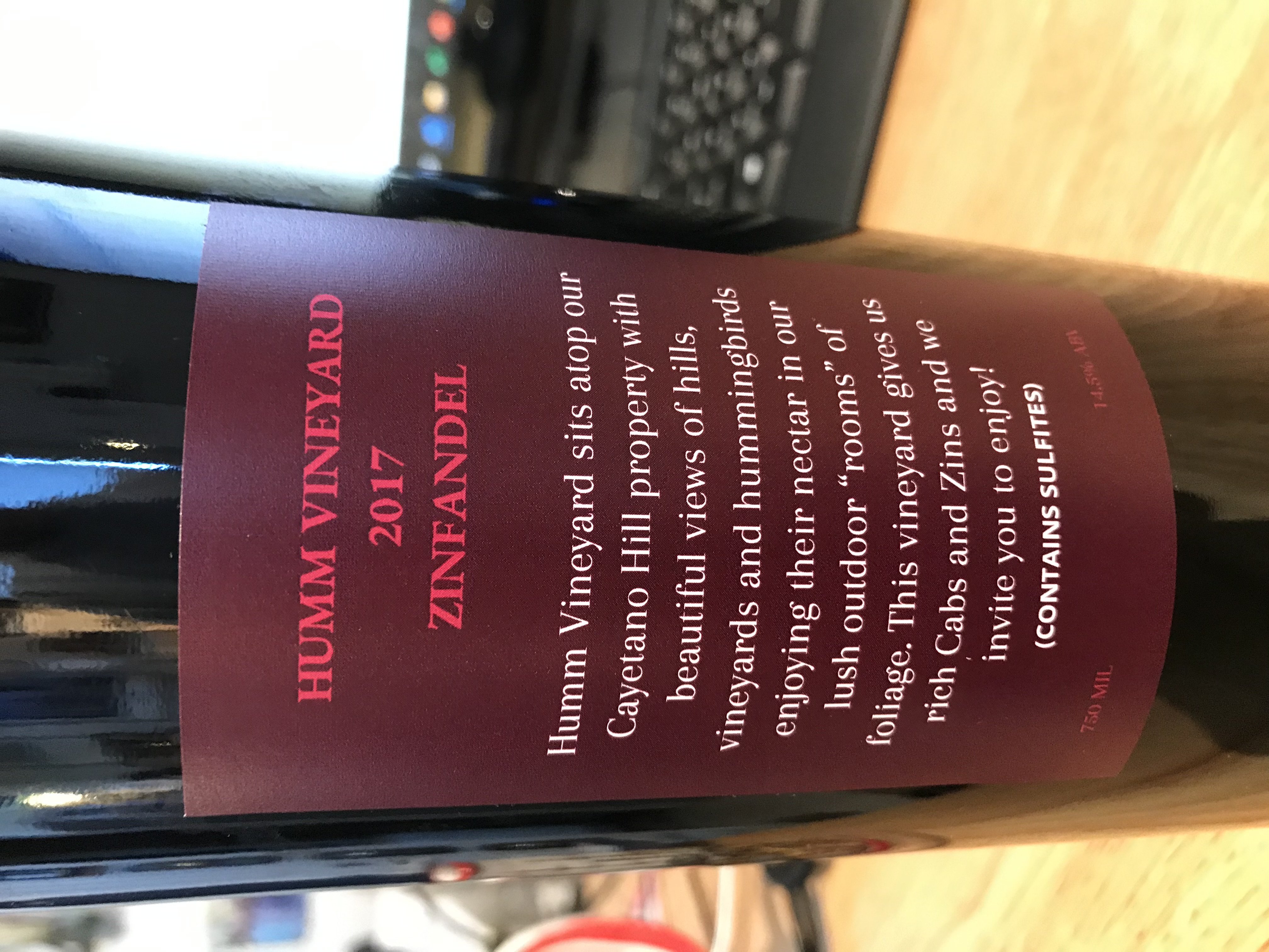 Back label of Humm 2017 Zinfandel with burgundy background